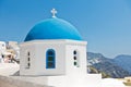 Blue dome of a white church with Caldera cliff in a background, Oia village, Santorini island Royalty Free Stock Photo