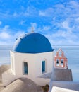 Blue-domed Greek church and belfry against volcano caldera on Santorini island, Cyclades, Greece Royalty Free Stock Photo