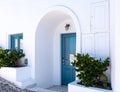 Blue door and blue window in traditional white Greek house at Santorini island, Greece. Royalty Free Stock Photo