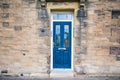 Blue door building with traditional silver handles and glass windows