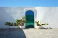 Blue door with cactus and the traditional white walls in the town of Ostuni Apulia region, Italy Royalty Free Stock Photo