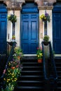 Blue Door, Colorful Stained Glass And Vibrant Flowers At The Entrance To A Victorian Tenement In Glasgow