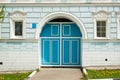 Blue Door Entrance In Stone Wall Of Residential Building. Royalty Free Stock Photo