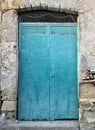 Blue door with faint writing on old building Greece Royalty Free Stock Photo