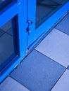 Blue door frame hinge on geometric tile floor Royalty Free Stock Photo