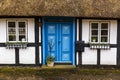 Blue door on old country house with thatched straw roof in Denmark Royalty Free Stock Photo