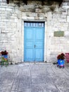 Blue door in old museum at Afytos, Kassanra, Chalkidiki. Flowers in pots in the center of the traditional village. Royalty Free Stock Photo