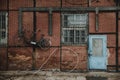 Blue door in red brick wall of half-timbered building with tandem bicycle hanging on the wall in docks of Gdansk Royalty Free Stock Photo