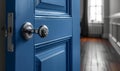 Blue door and silver doorknob in room with window and radiator