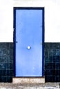 Blue door and white and blue tiled facade Royalty Free Stock Photo