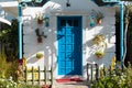 A blue door window is outside the white house in the summer garden Royalty Free Stock Photo