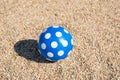Blue dotted ball on gravel