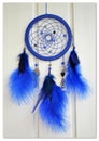 Blue dreamcatcher on a light background