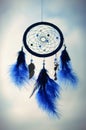 Blue dreamcatcher on a sky background