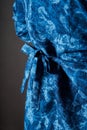 Blue dress fabric belt tied with a bow at the back. Women& x27;s clothing item made of thick cotton fabric close-up Royalty Free Stock Photo