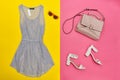 Blue dress, pink handbag, white shoes and rose-colored glasses. Bright pink and yellow background Royalty Free Stock Photo