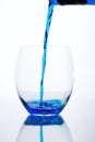 Blue drink is flowed into a glass Royalty Free Stock Photo