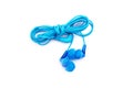 Blue earbuds isolated on white background. Neatly coiled wire headphones