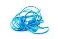 Blue earbuds isolated on white background. Tangled and twisted wire headphones Royalty Free Stock Photo