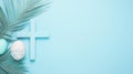 Blue Easter cross, decorated eggs and palm leaf on pastel blue background Royalty Free Stock Photo