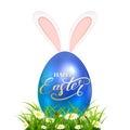 Blue Easter egg in grass with rabbit ears on white background Royalty Free Stock Photo