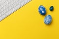 Blue Easter eggs with keypad on yellow background