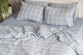 Blue ecologycal linen on bed in modern home interior. Daylight Royalty Free Stock Photo