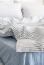 Blue ecologycal linen on bed in modern home interior. Daylight Royalty Free Stock Photo