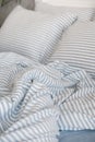 Blue ecologycal linen on bed in modern home interior. Daylight Royalty Free Stock Photo