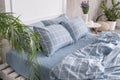 Blue ecologycal linen on bed in modern home interior. Daylight Royalty Free Stock Photo