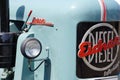 Blue Eicher truck with a logo on the side of the driver's side door, parked in a parking lot