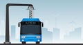 Blue electric bus at a stop is charged by pantograph.