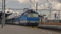 Blue electric engine with fast train to Prague arriving from Pilsen main station Royalty Free Stock Photo