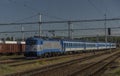 Blue electric engine with passenger coaches in Valasske Mezirici station