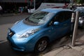 Blue, electric Nissan Leaf charging in the streets of Oslo, Norway