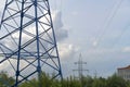 A blue electric pole transmits energy. High voltage line with wires. Electricity transmission, volt Royalty Free Stock Photo