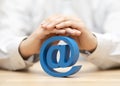 Blue email symbol protected by hands Royalty Free Stock Photo