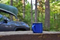 Blue emanel coffe cup in nature. Morning preparation for canoe padling day. Royalty Free Stock Photo
