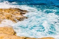 Blue emerald sea water with large stones beach. Rocky shore transparent turquoise bottom Malta Royalty Free Stock Photo