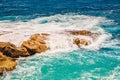 Blue emerald sea water with large stones beach. Rocky shore transparent turquoise bottom Malta Royalty Free Stock Photo