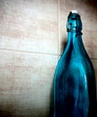 A blue empty bottle in the kitchen before the tile Royalty Free Stock Photo