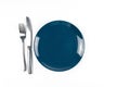 Blue empty plate with fork and knife isolated on white background Royalty Free Stock Photo