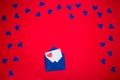Blue envelope with love letter above red background Royalty Free Stock Photo