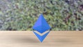 Blue Ethereum gold sign icon on wood table on leaves background. 3d render isolated illustration, cryptocurrency, crypto, business