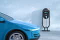 Blue ev car or electric vehicle plug in with recharging station Royalty Free Stock Photo