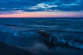 Blue evening on the sea coast with small waves on old snag, desctop wallpaper Royalty Free Stock Photo