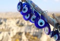 Blue Evil Eye Nazar Turkish Charms on tree with Cappadocia Background in Goreme