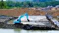 Blue excavator in construction site