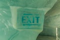 Blue exit sign graved in ice with arrows Royalty Free Stock Photo
