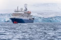 blue expedition ship in front of antarctic iceberg landscape in Cierva Cove Royalty Free Stock Photo